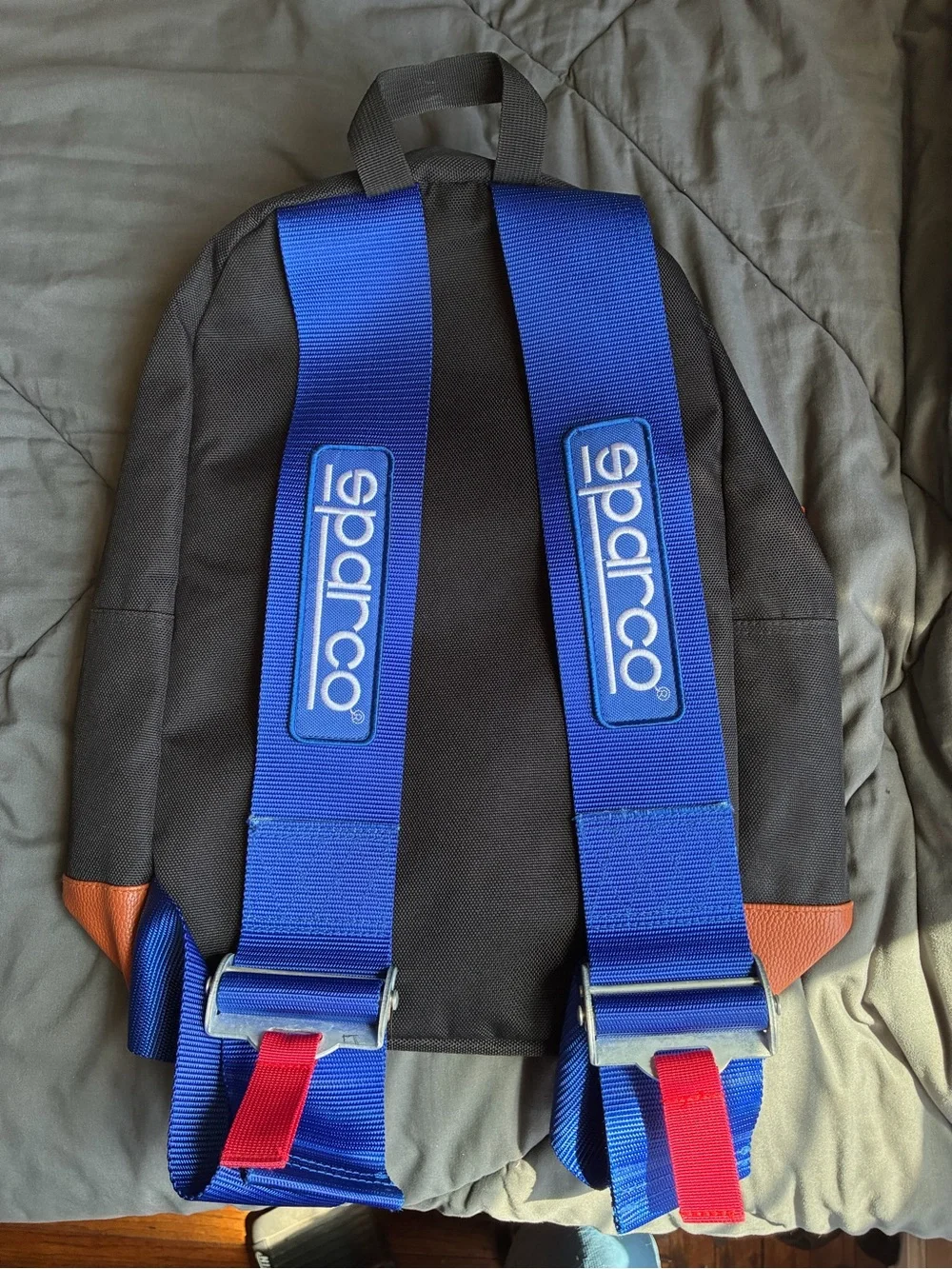 Black Backpack with Orange Trim and Blue Strap